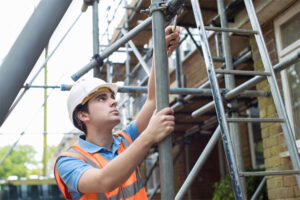 A Person in a Hard Hat Working on a Scaffolding  — West Valley City, UT — Savage Scaffold & Equipment Co.